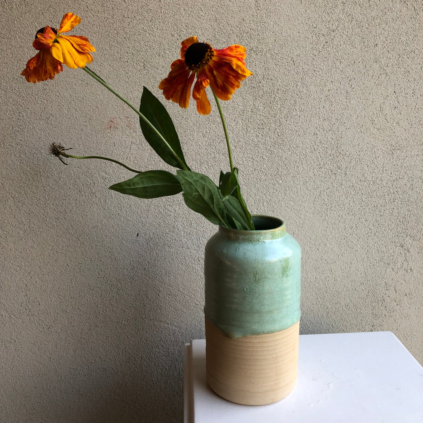 Vase with a dip in green glaze